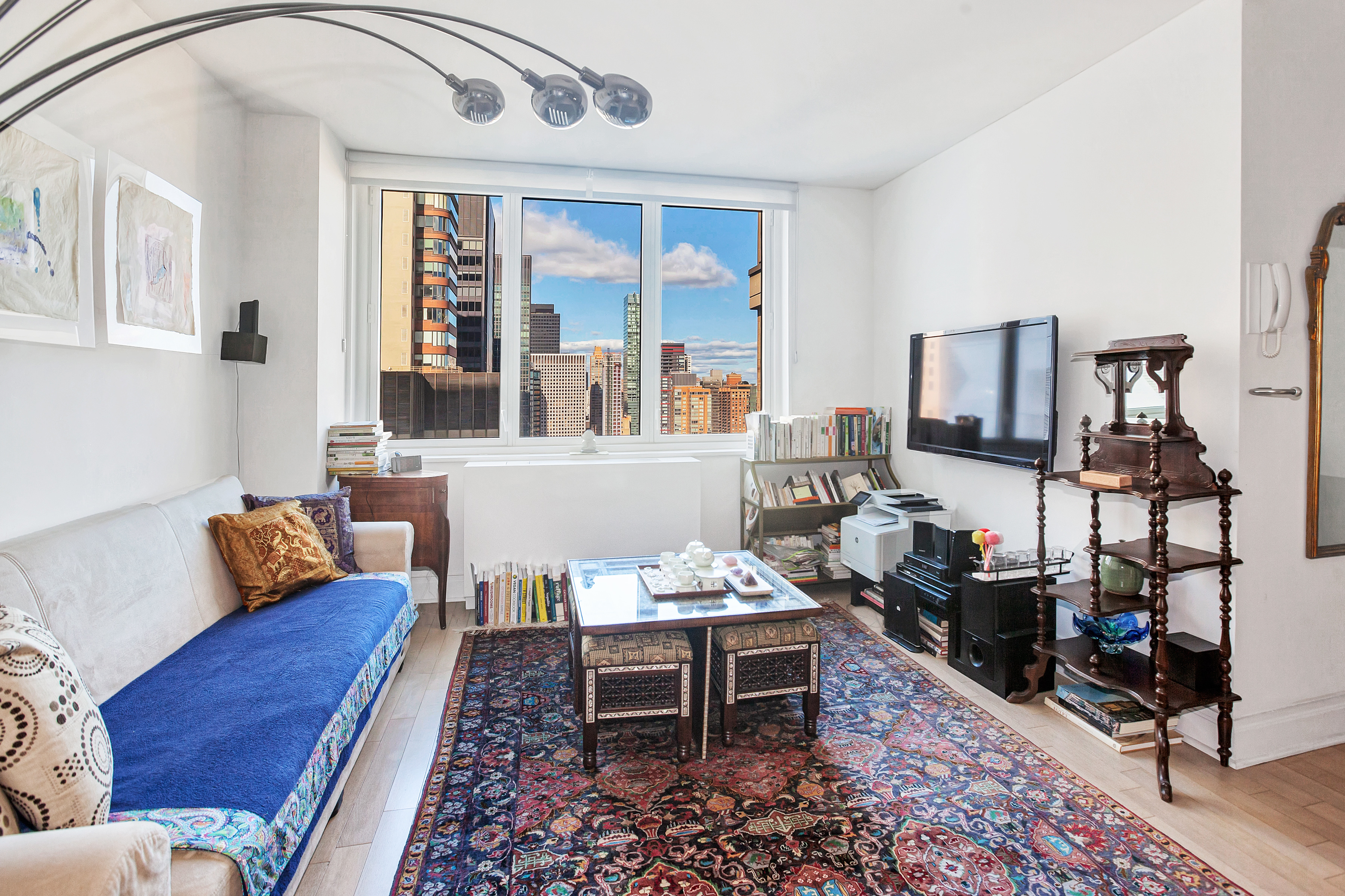 212 East 47th Street, Unit PHB Manhattan, NY 10017 - Photo 2 of 6 a living room with furniture and a window