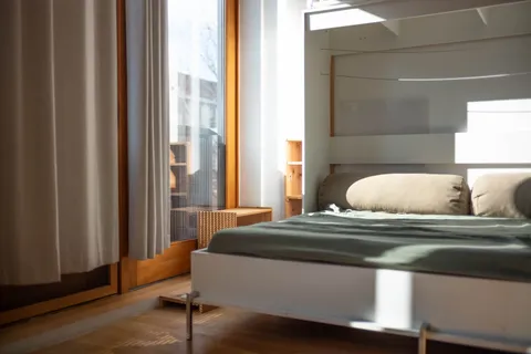 a bedroom with a bed and window