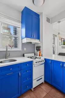 a kitchen with stainless steel appliances wooden cabinets and a stove top oven