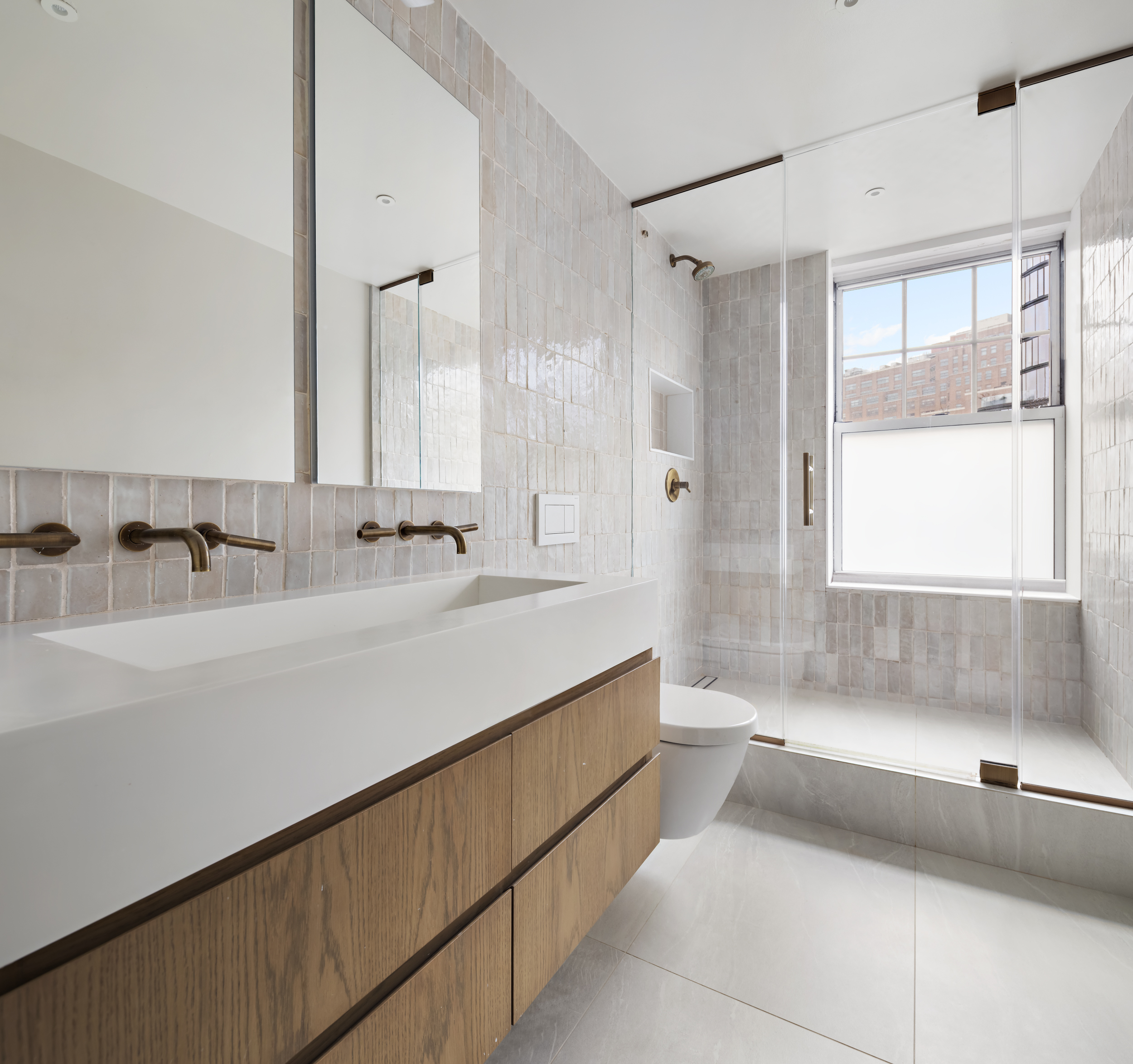 2 Horatio Street, Unit 4JS Manhattan, NY 10014 - Photo 16 of 20 a bathroom with a tub sink and mirror