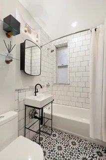 a bathroom with a sink toilet a mirror and shower