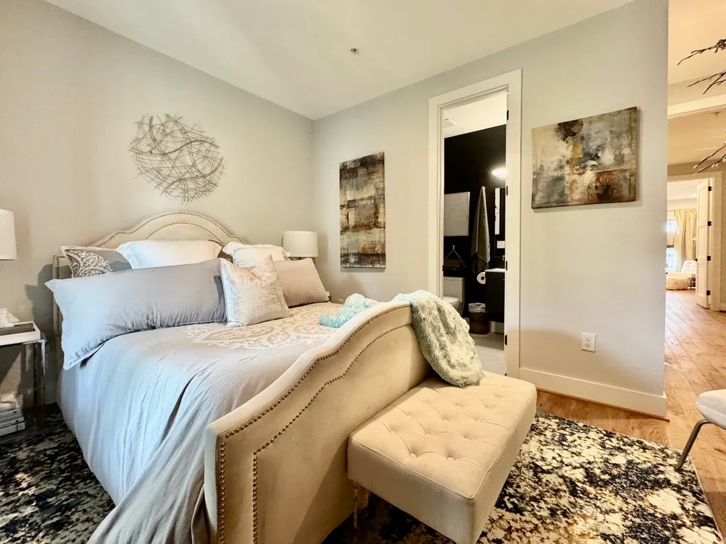 a bedroom with a bed and wooden floor