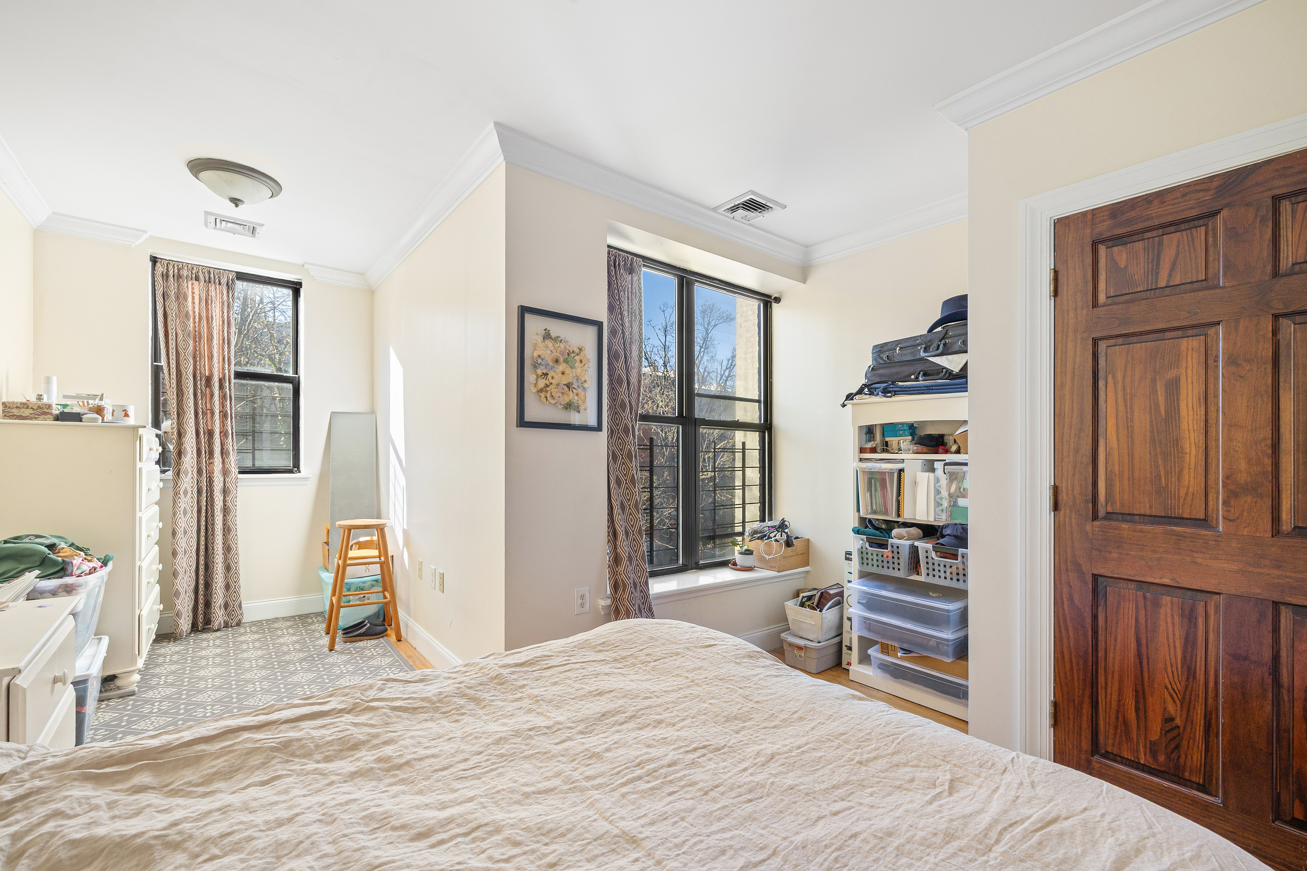 518 West 149th Street Manhattan, NY 10031 - Photo 17 of 23 a bedroom with a bed dresser and a window