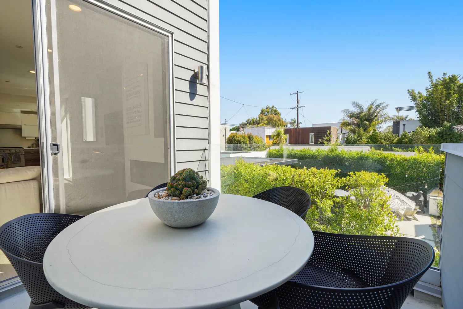a view of a dining room with a table and a potted plant