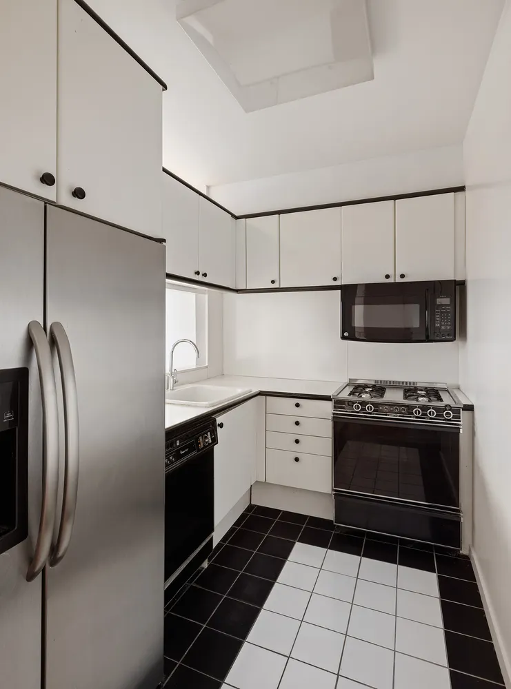 a kitchen with stainless steel appliances granite countertop a stove and a refrigerator