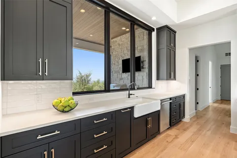 a spacious bathroom with a granite countertop sink a large mirror and window