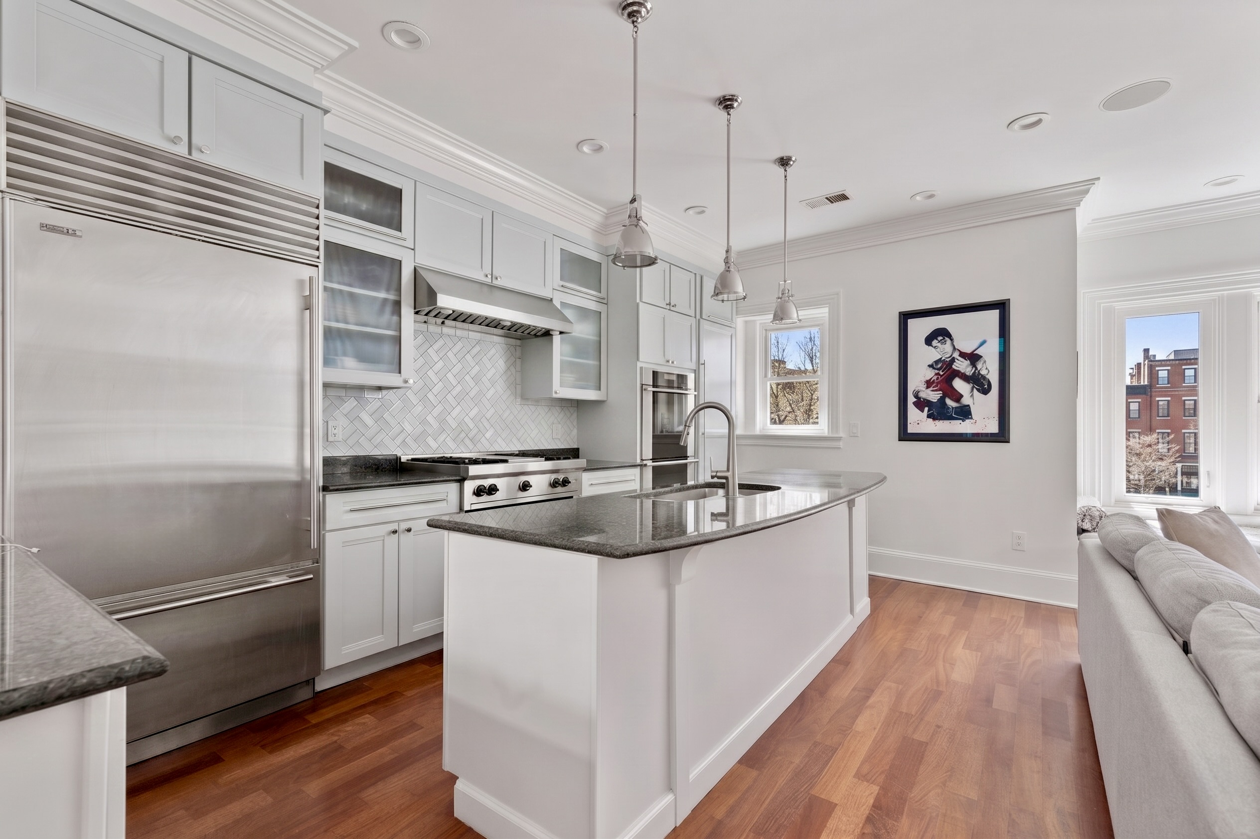 321 Commonwealth Avenue, Unit 40 Boston, MA 02115 - Photo 4 of 10 a kitchen with stainless steel appliances granite countertop a sink and a refrigerator