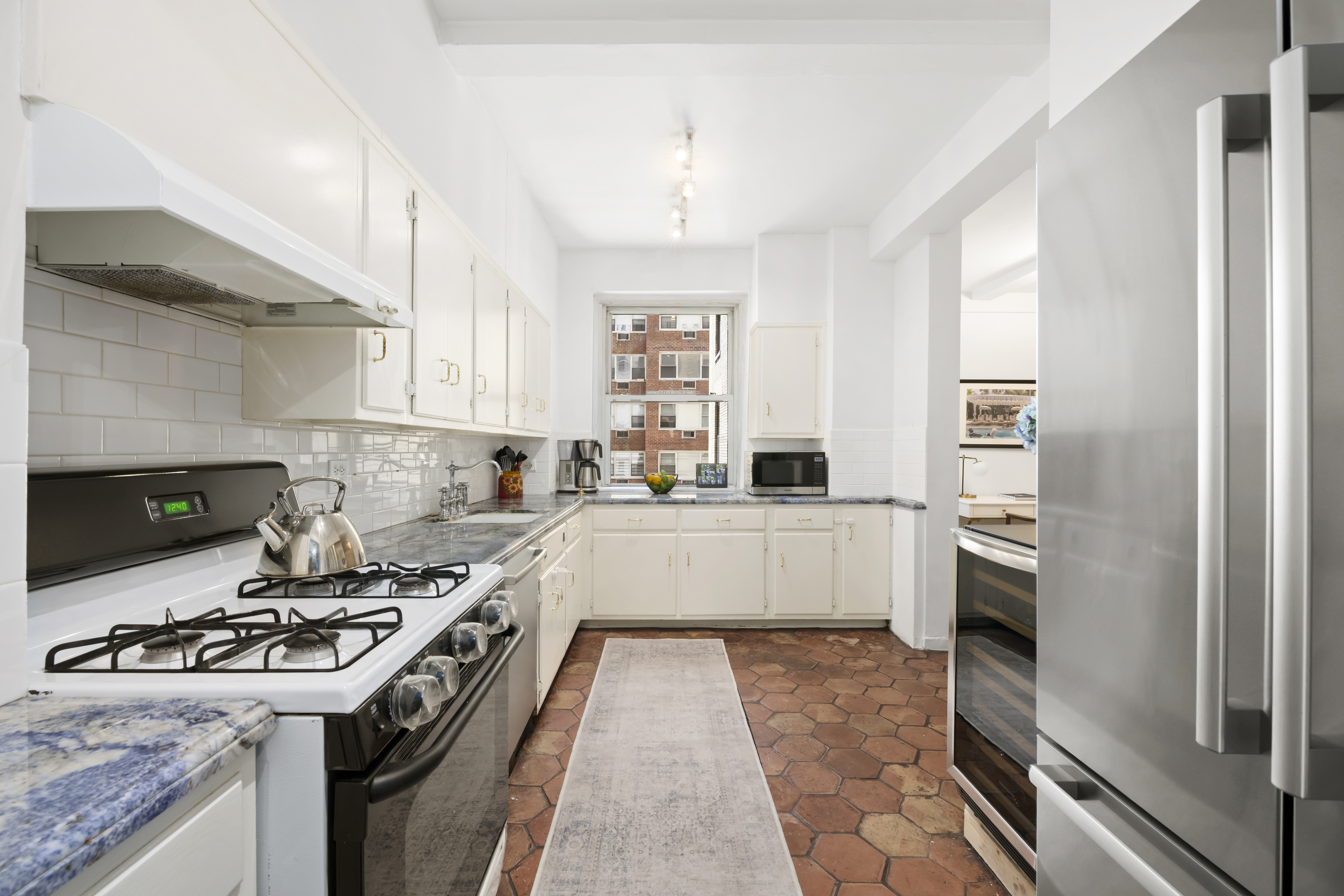 320 East 72nd Street, Unit 6A Manhattan, NY 10021 - Photo 8 of 13 a kitchen with a stove sink and refrigerator