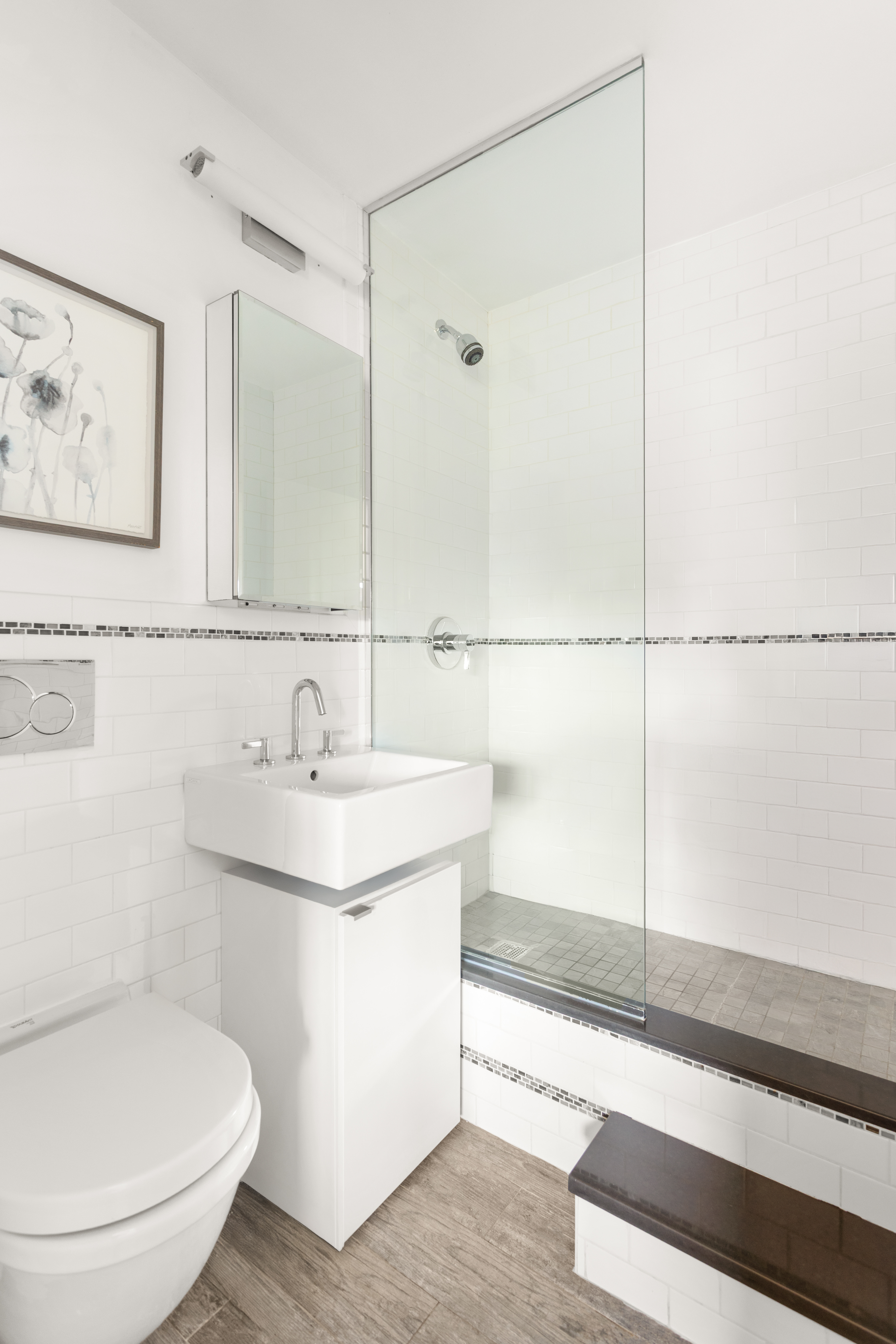 417 Grand Street, Unit D1801 Manhattan, NY 10002 - Photo 11 of 23 a bathroom with a sink and a mirror