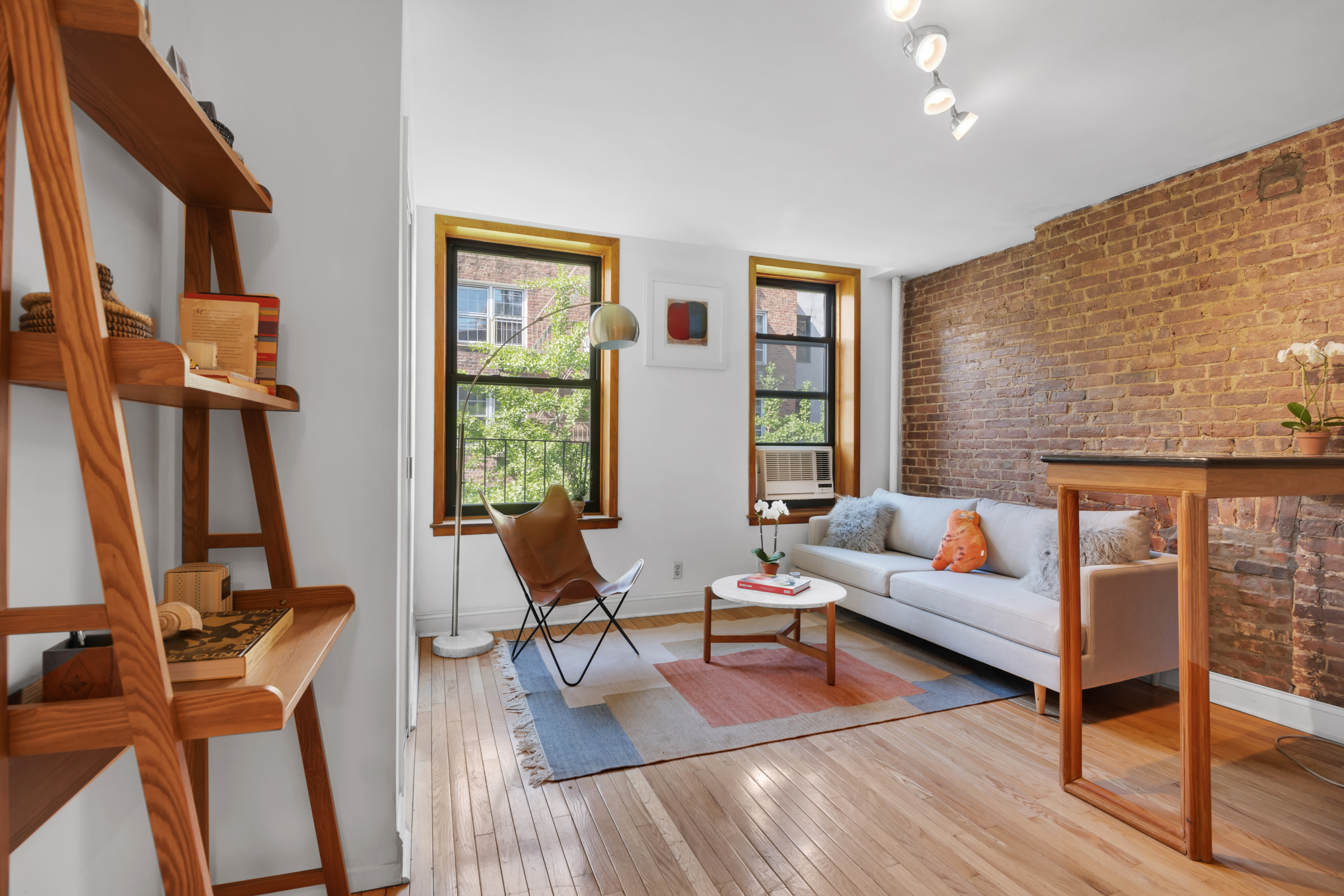 220 East 82nd Street, Unit 4RW Manhattan, NY 10028 - Photo 3 of 11 a living room with fireplace furniture and a wooden floor