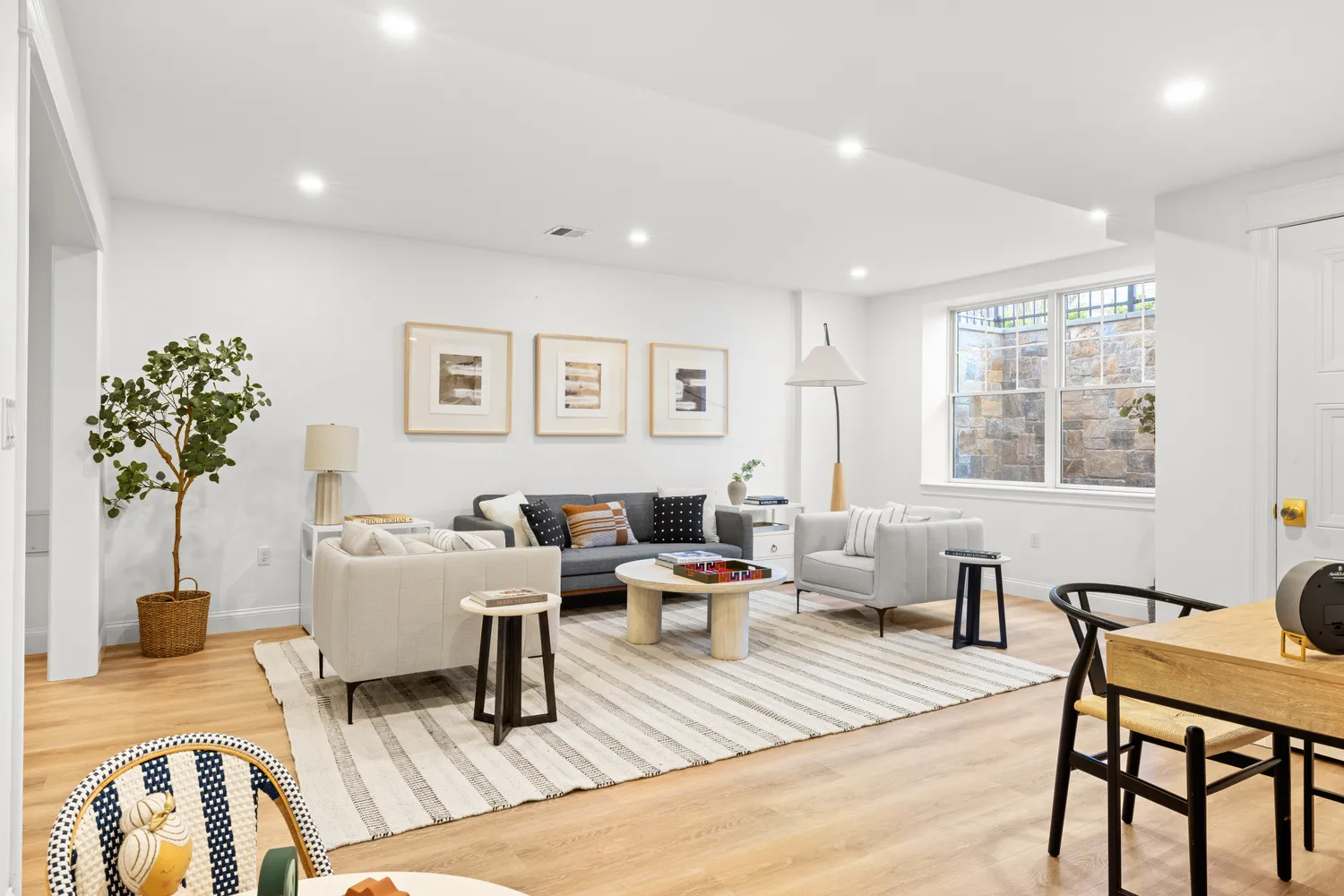 a living room with furniture and a potted plant