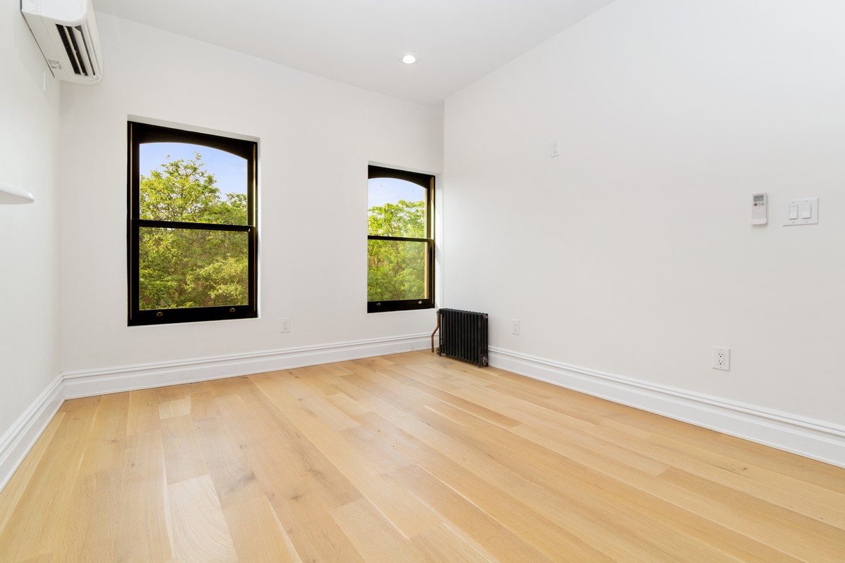 354 Macon Street, Unit 2 Brooklyn, NY 11233 - Photo 7 of 13 an empty room with windows