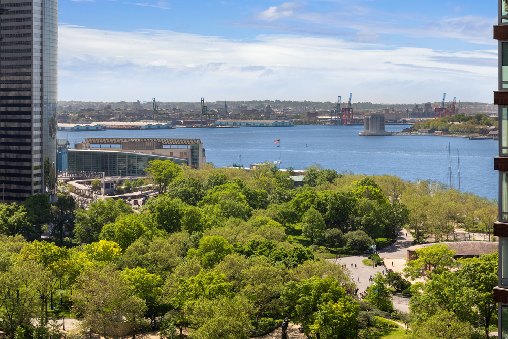 30 West Street, Unit 19F Manhattan, NY 10004 - Photo 10 of 12 a view of a lake with houses