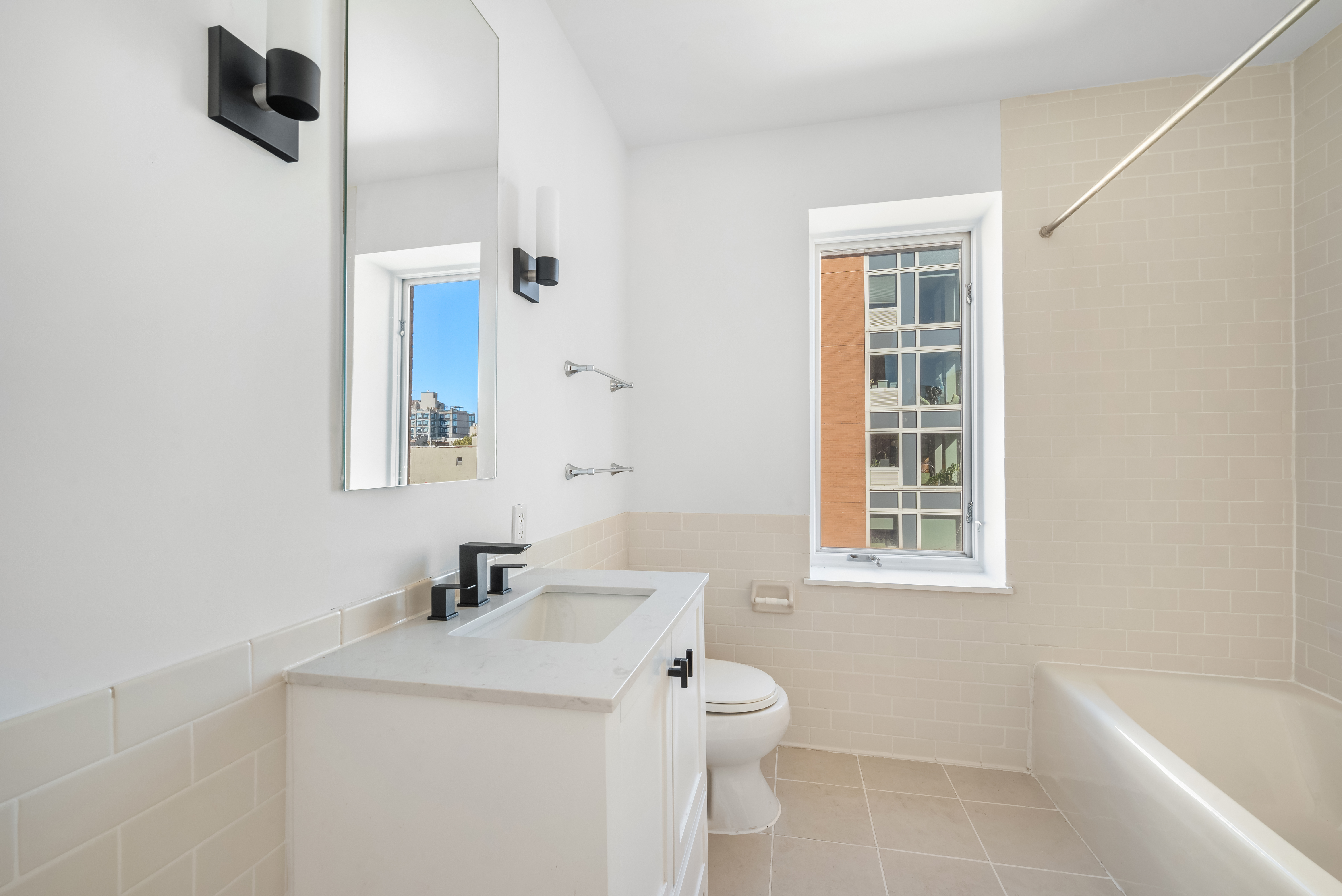 304 West 115th Street, Unit 6A Manhattan, NY 10026 - Photo 9 of 14 a bathroom with a sink a toilet and shower