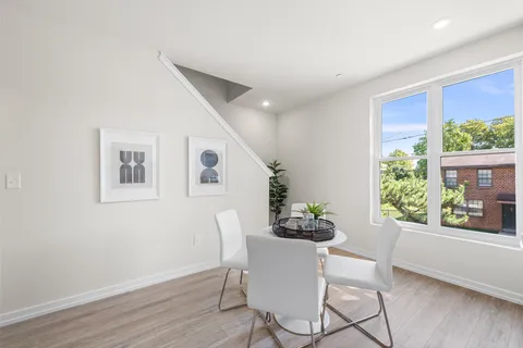 a bedroom with a bed couch and painting on the wall
