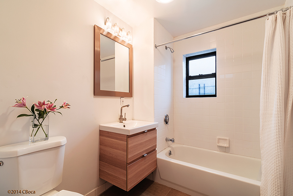 404 Classon Avenue, Unit 2 Brooklyn, NY 11238 - Photo 8 of 14 a bathroom with a tub sink and mirror