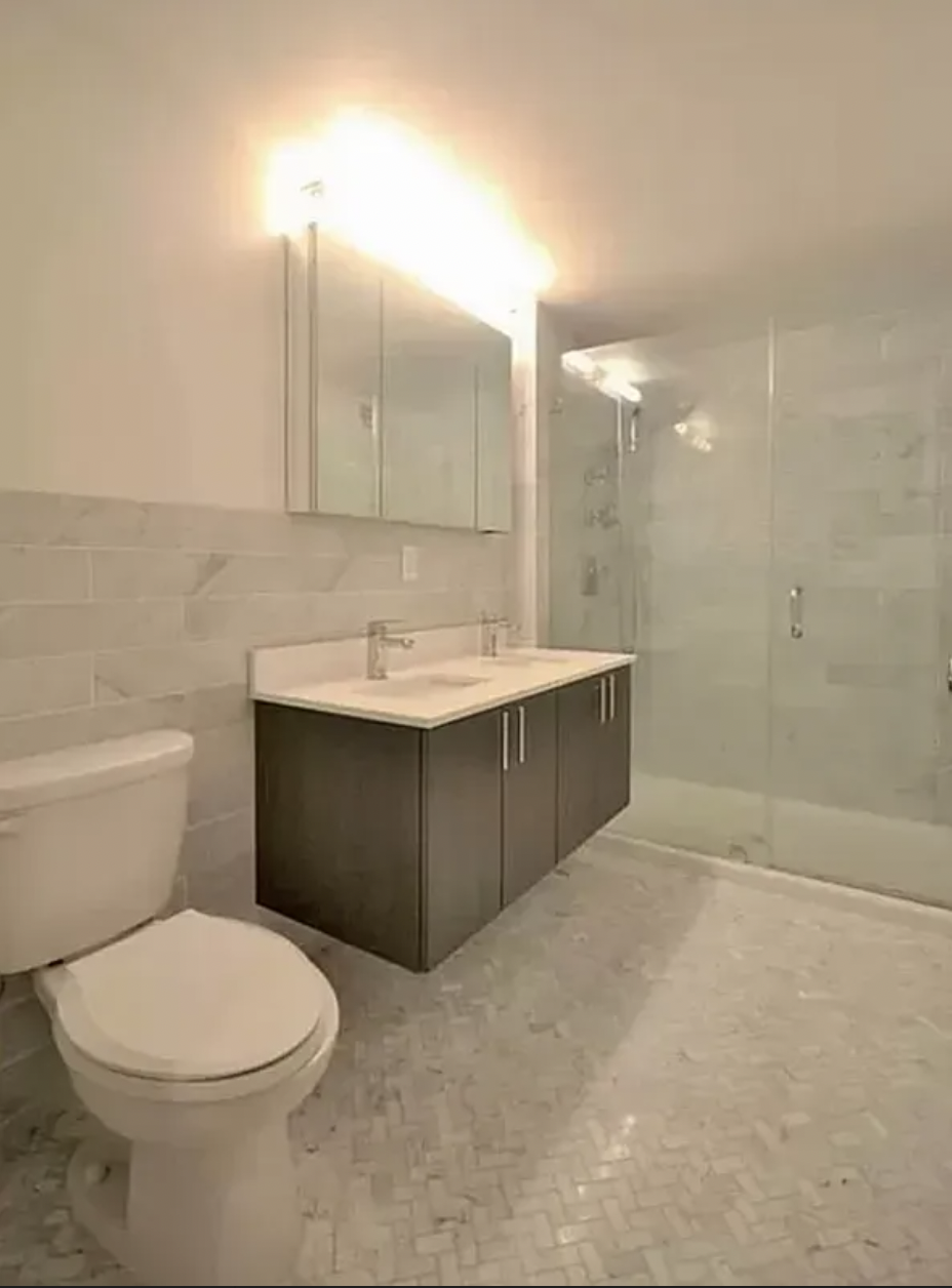 44 Berry Street, Unit 3A Brooklyn, NY 11249 - Photo 5 of 8 a bathroom with a sink a toilet and a mirror