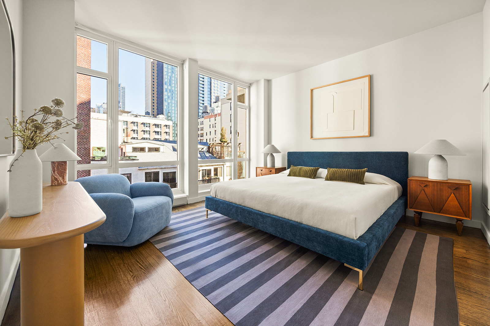 133 West 22nd Street, Unit 8G Manhattan, NY 10011 - Photo 5 of 16 a bedroom with a bed couch and a window