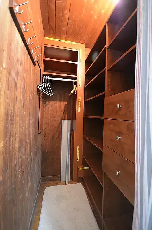 a view of walk in closet with empty racks