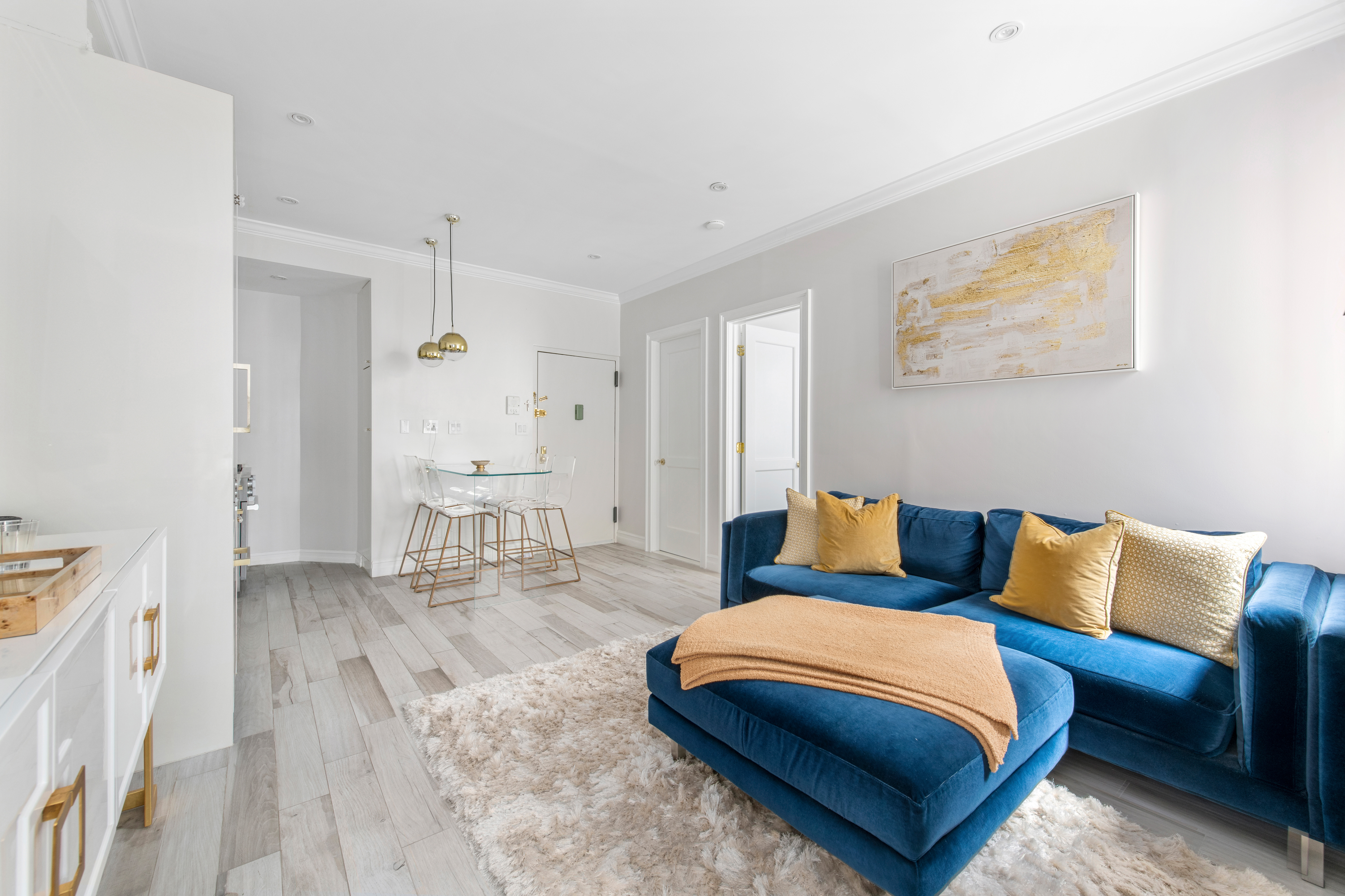 135 Ridge Street, Unit 5A Manhattan, NY 10002 - Photo 2 of 11 a living room with furniture and a table