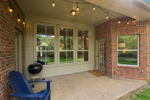 a view of a lobby with a floor to ceiling windows and potted plant