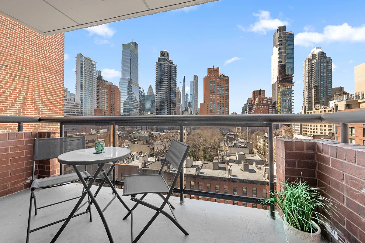 300 East 62nd Street, Unit 1001 Manhattan, NY 10065 - Photo 2 of 10 a view of a city from a balcony with chairs