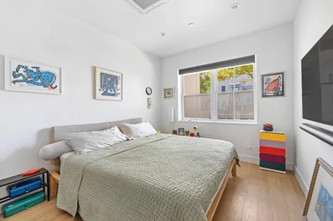 a bedroom with a bed and a large window