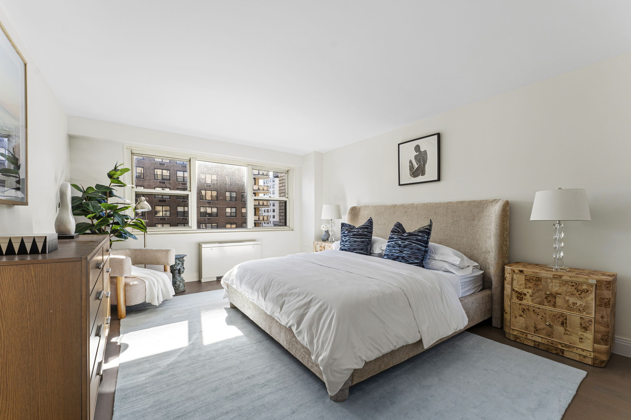 245 East 87th Street, Unit 17C Manhattan, NY 10128 - Photo 7 of 11 a bedroom with a large bed and a large window