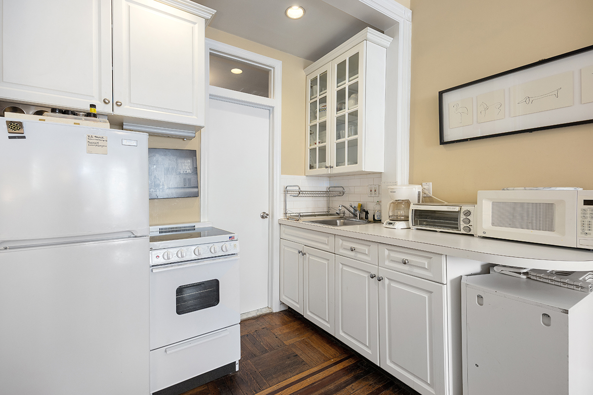 119 West 80th Street, Unit 3F Manhattan, NY 10024 - Photo 4 of 7 a kitchen with cabinets appliances and a sink