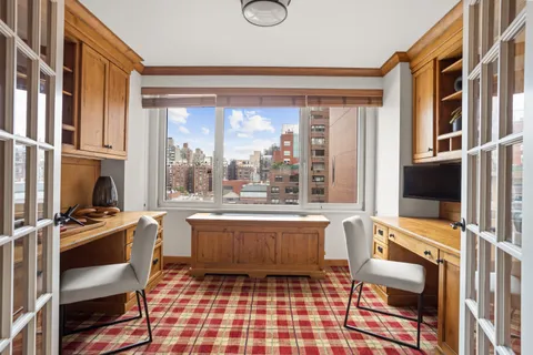 a living room with patio furniture and a flat screen tv