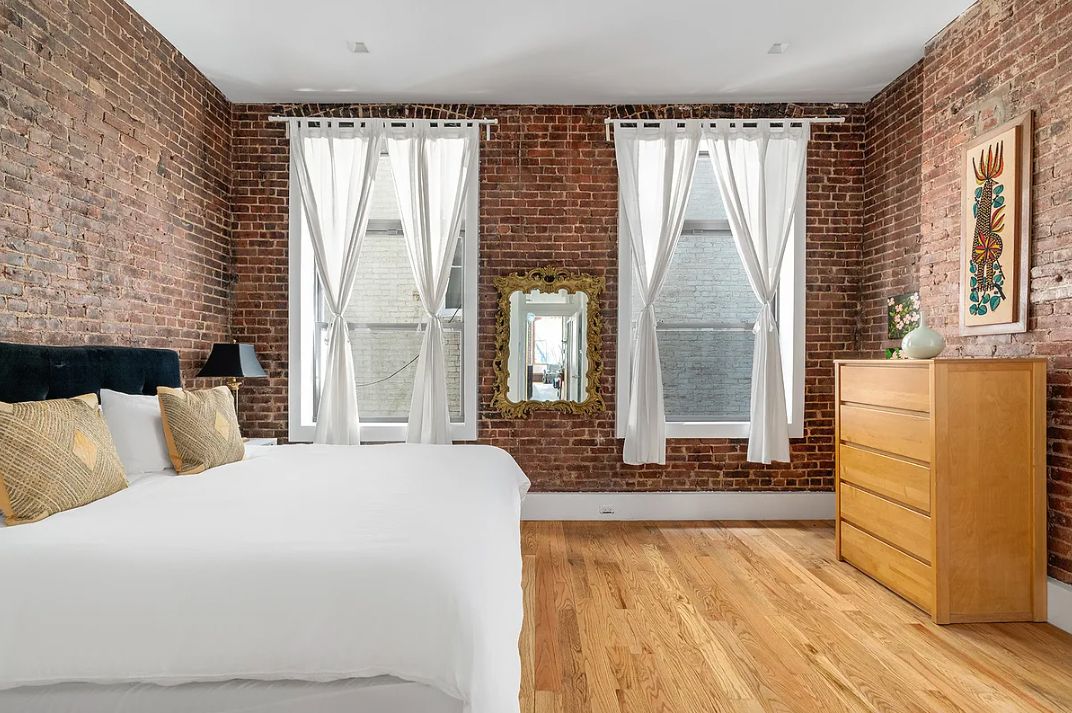 293 Church Street, Unit 5 Manhattan, NY 10013 - Photo 5 of 8 a bedroom with a bed and wooden floor