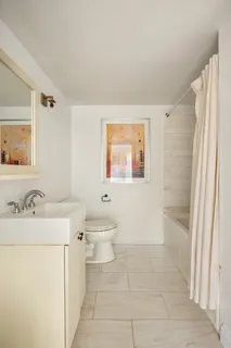 a bathroom with a sink a toilet and a mirror