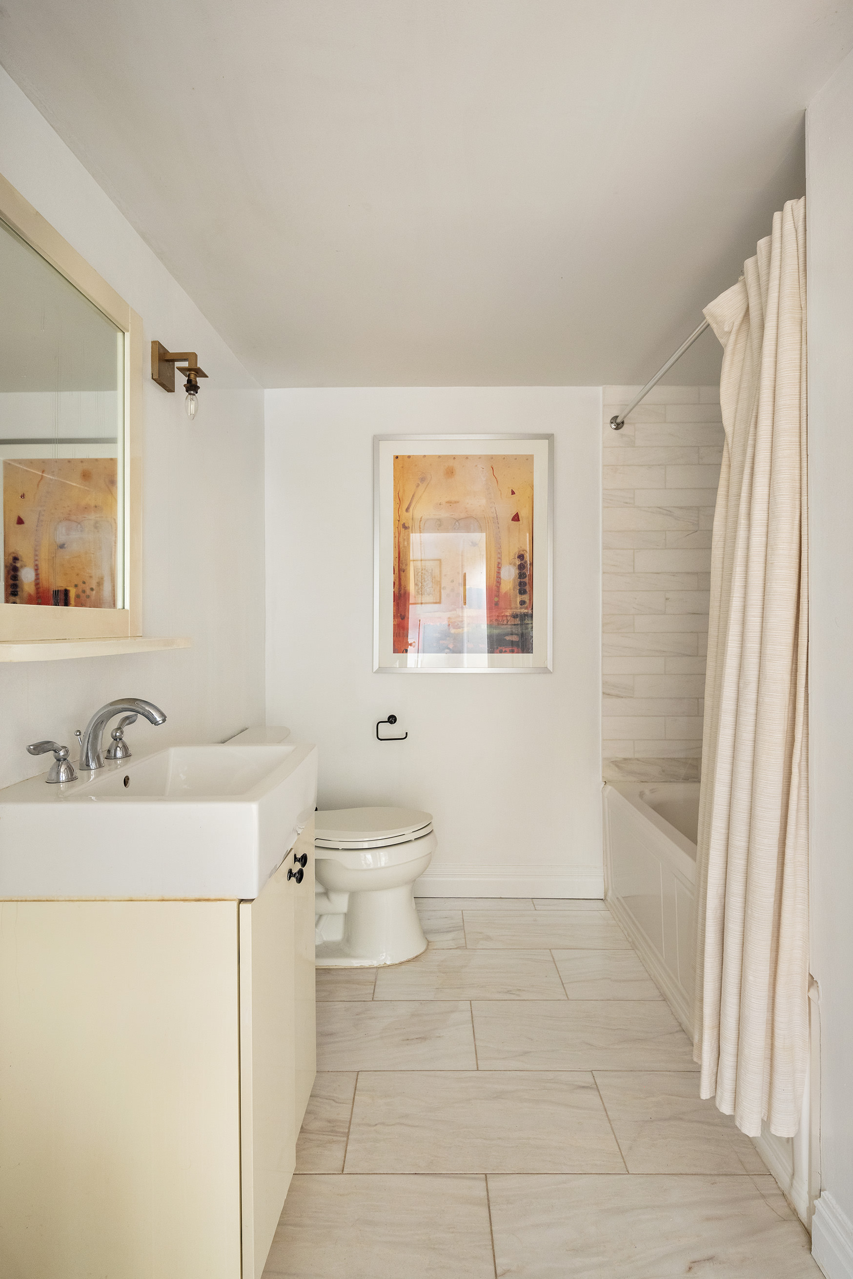 341 West 29th Street, Unit 1 Manhattan, NY 10001 - Photo 9 of 11 a bathroom with a sink a toilet and a mirror