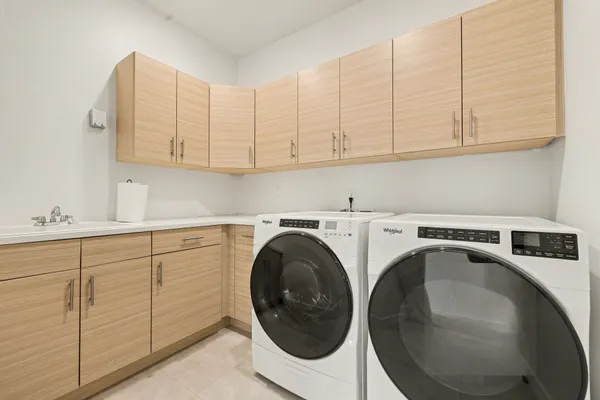 a utility room with sink dryer and washer