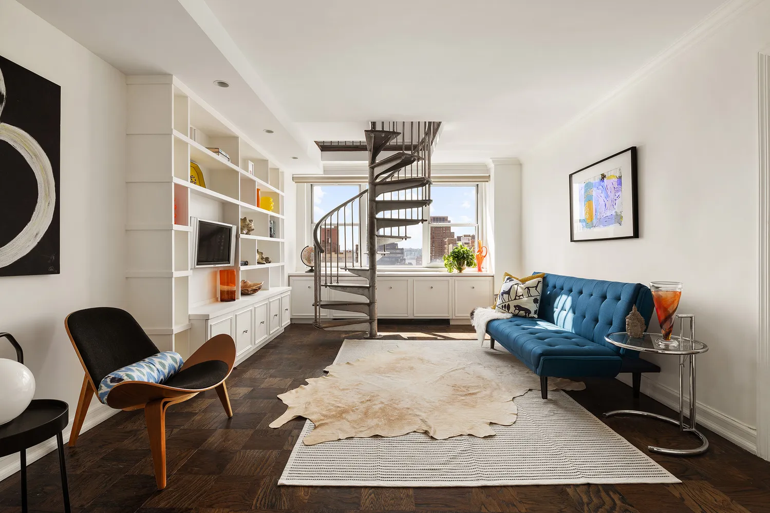 a living room with furniture and a painting on the wall