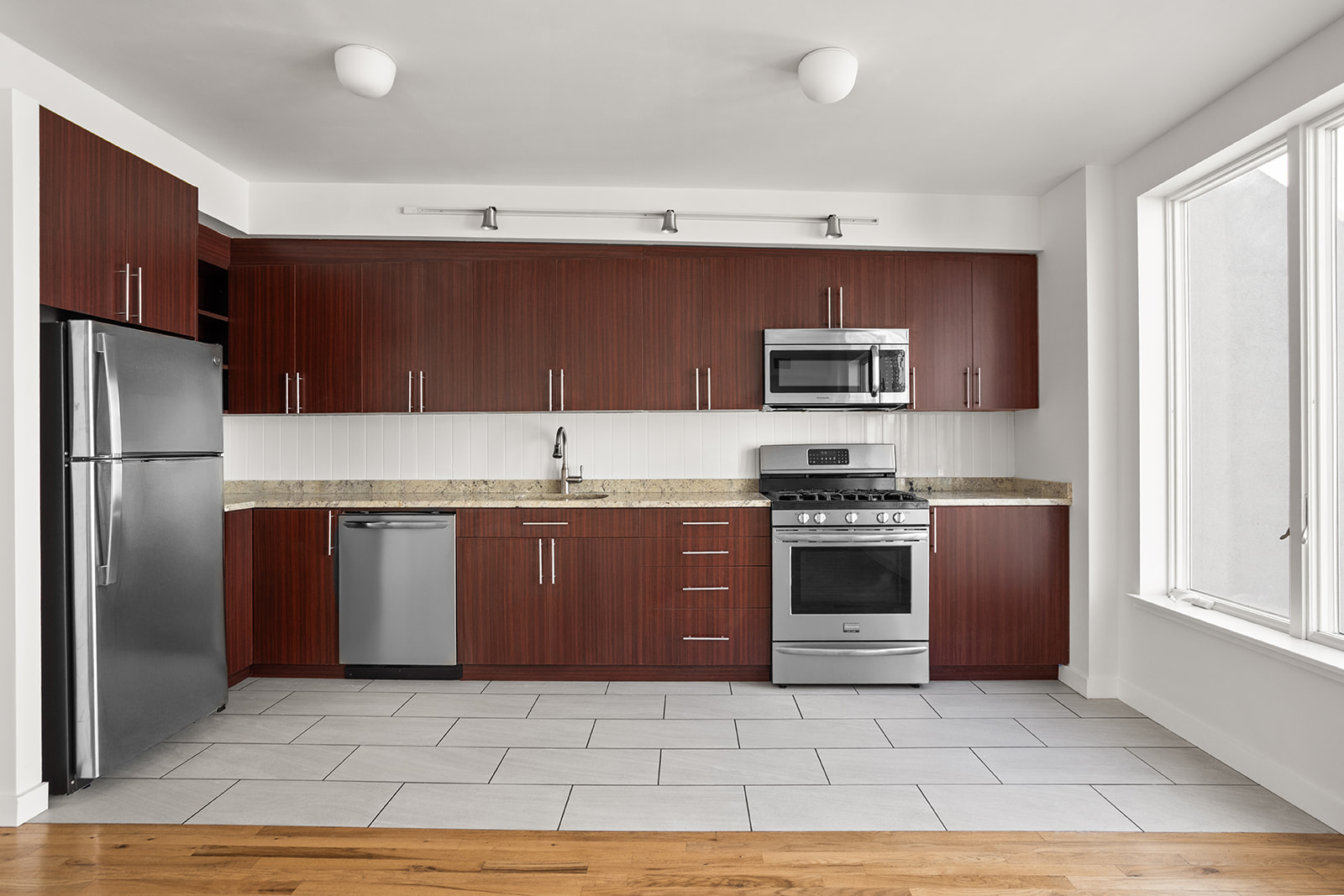 65 Jackson Street, Unit 2 Brooklyn, NY 11211 - Photo 2 of 7 a kitchen with stainless steel appliances granite countertop a stove a refrigerator and a sink