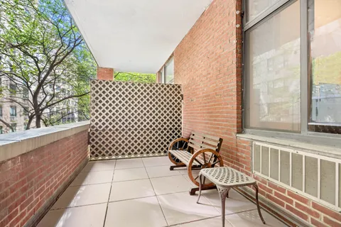 a view of a bench in wooden deck