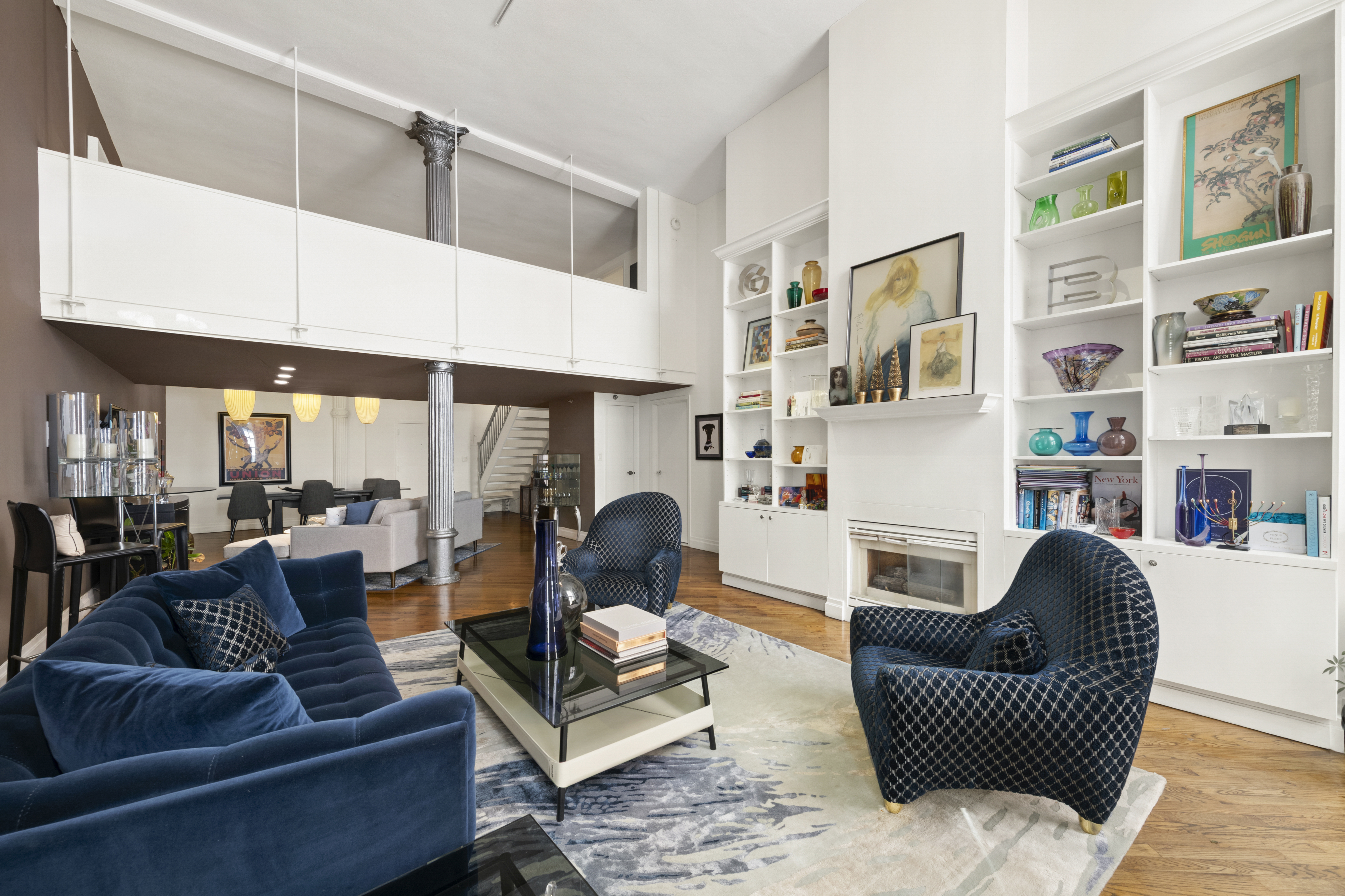 121 West 20th Street, Unit 2D Manhattan, NY 10011 - Photo 2 of 12 a living room with furniture and a fireplace