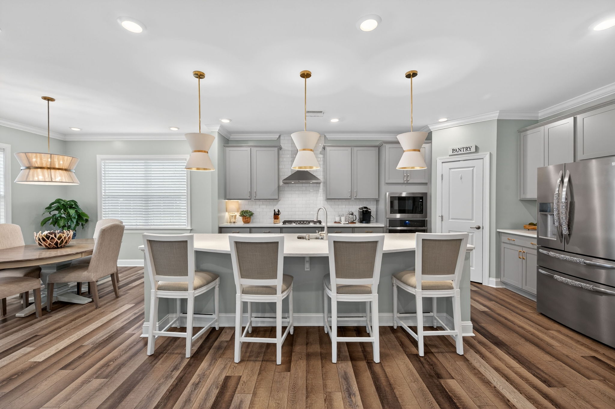 118 Mahogany Run Raleigh, NC 27610 - Photo 16 of 43 a kitchen with stainless steel appliances a dining table chairs and white cabinets