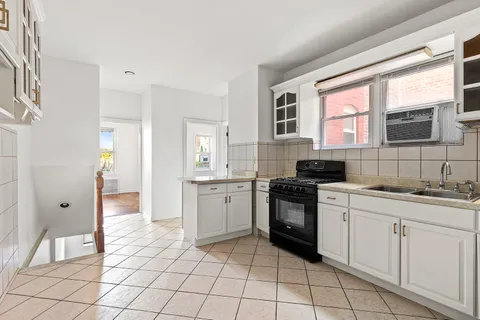 a kitchen with a stove a sink and a refrigerator