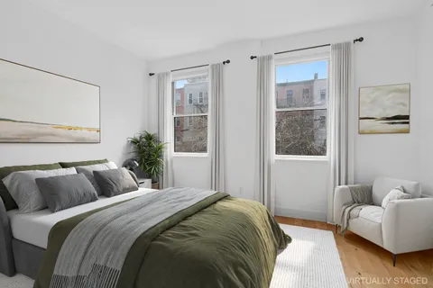 a bedroom with a balcony a bed and a couch