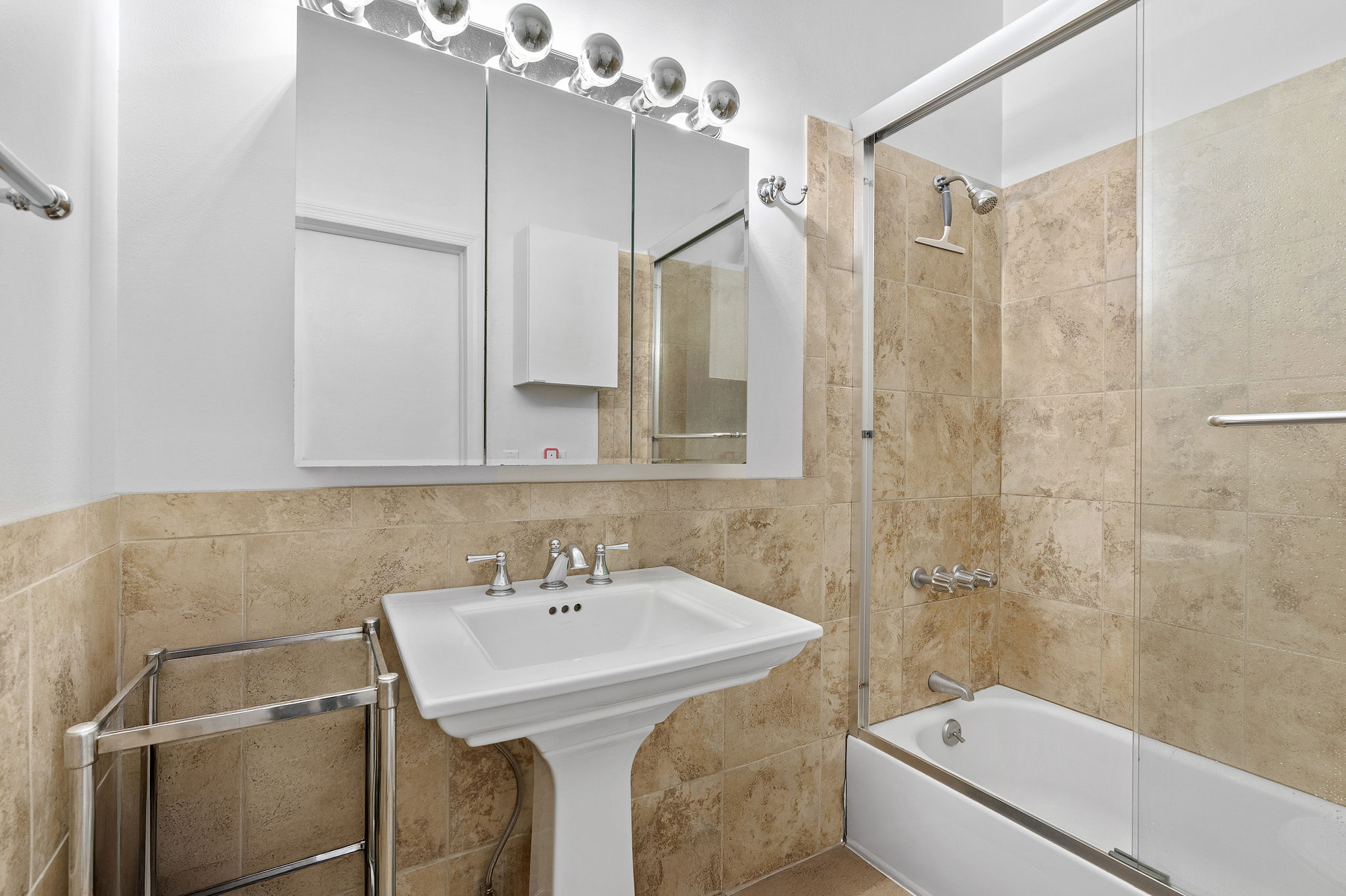 565 Broadway, Unit 8W Manhattan, NY 10012 - Photo 12 of 23 a bathroom with a sink a toilet and shower