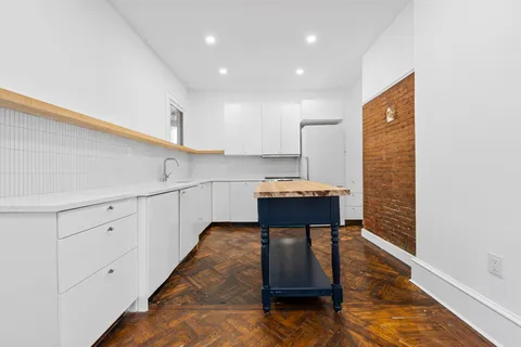 a kitchen with a refrigerator and a sink
