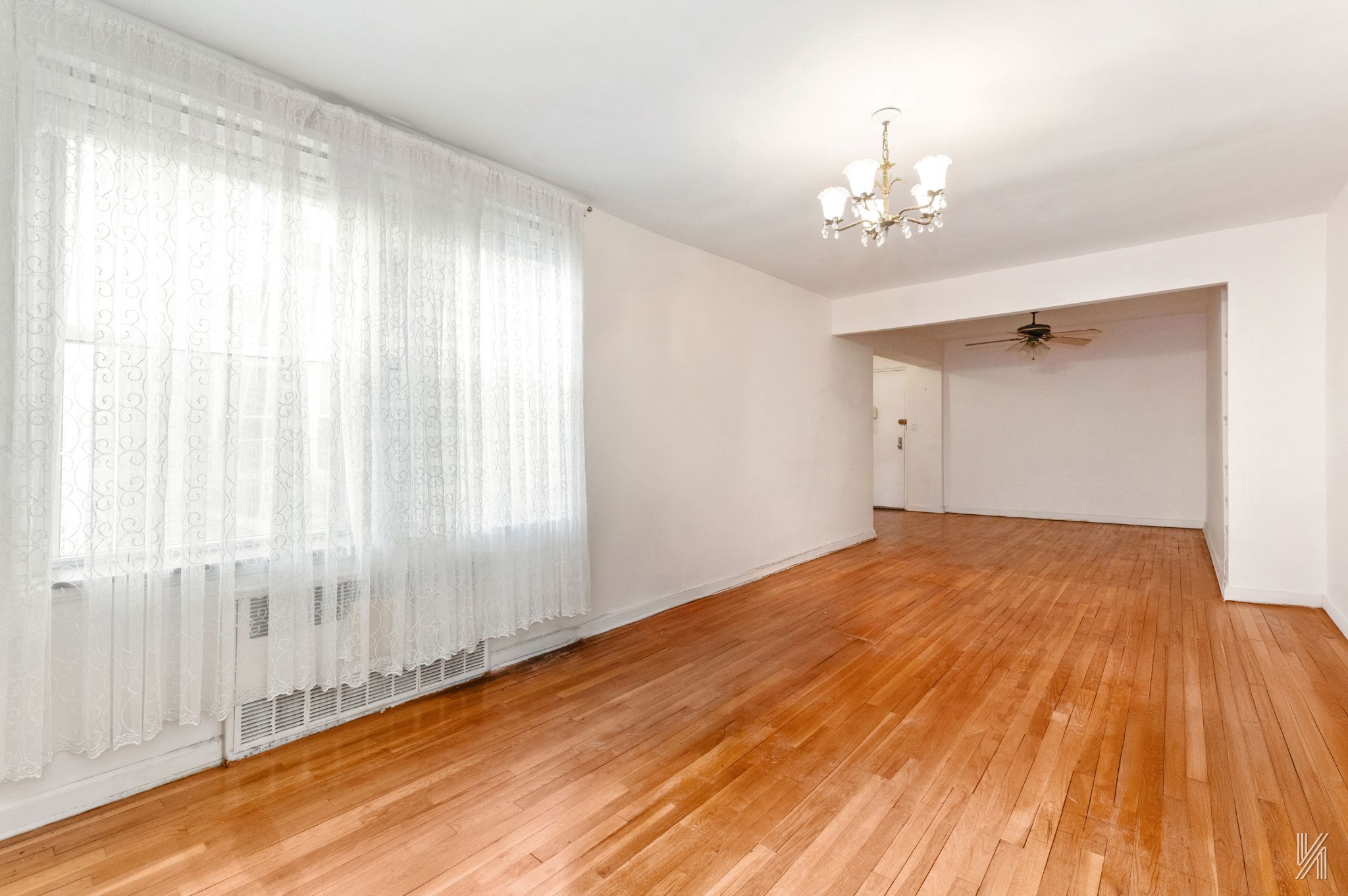 33-45 92nd Street, Unit 5G Queens, NY 11372 - Photo 2 of 8 a view of a livingroom with a chandelier