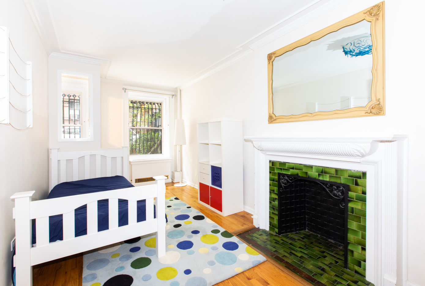 27 West 87th Street, Unit 1 Manhattan, NY 10024 - Photo 9 of 12 a bedroom with furniture and a fireplace