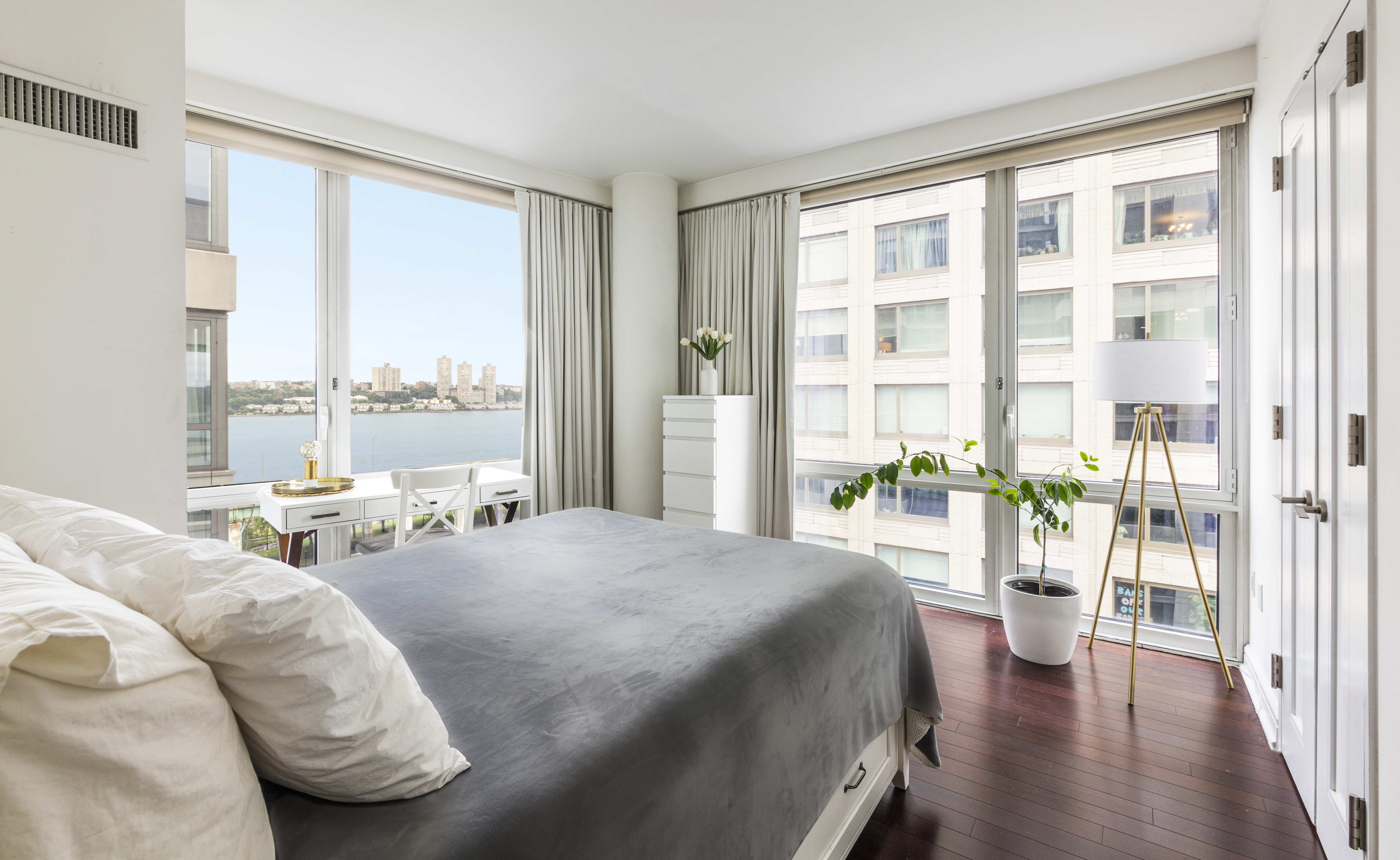 80 Riverside Boulevard, Unit 9E Manhattan, NY 10069 - Photo 6 of 14 a large bedroom with a bed and a large window