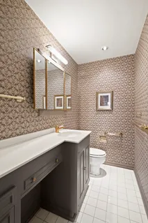 a bathroom with a sink a toilet and mirror