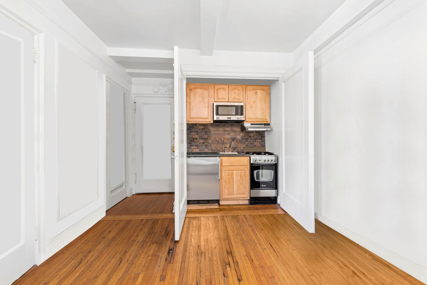 457 West 57th Street, Unit 1501 Manhattan, NY 10019 - Photo 2 of 6 a view of a kitchen cabinets a sink and wooden floor