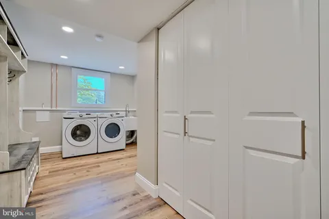 a view of a storage and utility room with washer and dryer