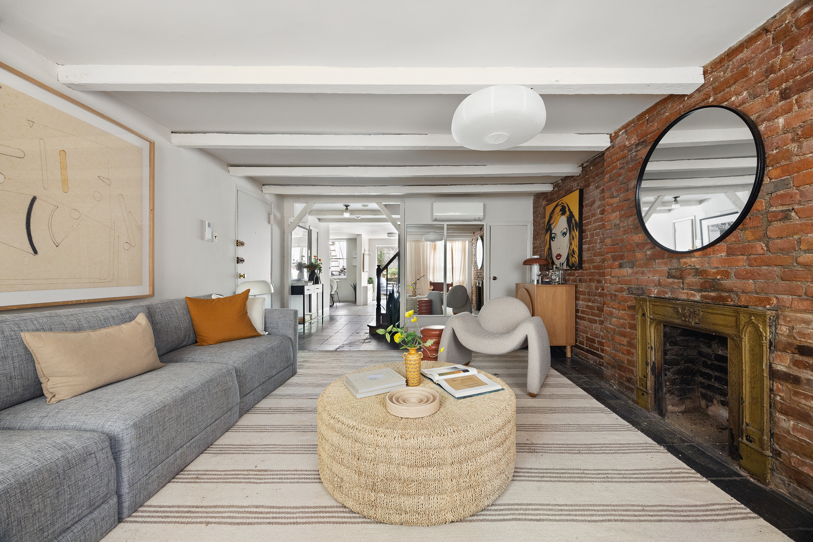 765 Greenwich Street, Unit 1 Manhattan, NY 10014 - Photo 1 of 18 a living room with furniture a fireplace and a large window